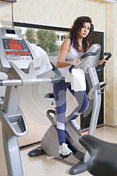 Woman at the gym doing cardio bycicle