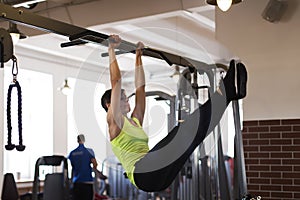 Woman at the gym doing exercises the legs to the top