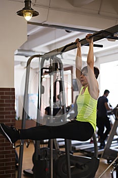 Woman at the gym doing exercises the legs to the top