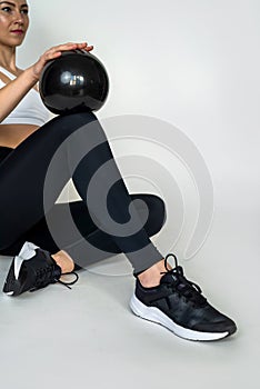 woman in the gym doing sports with pilates ball isolated on white wall.