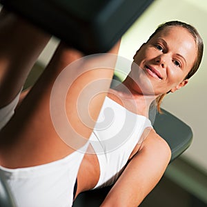 Woman in gym on machine