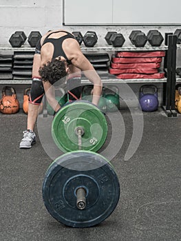 Woman in the gym prepared to train weight exercises