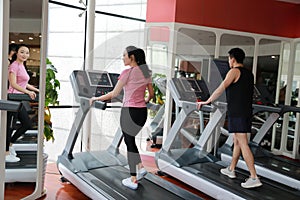 Woman in gym running on a treadmill