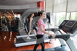 Woman in gym running on a treadmill