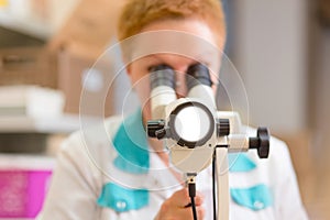Woman gynecologist working with colposcope photo