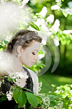 Woman with a hair braid in a blossoming park.