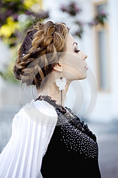 Woman with a hair braid in a blossoming park.