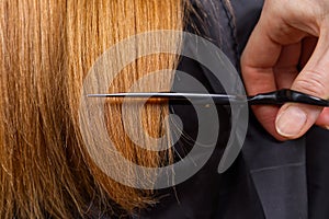 Woman hair care. Hairdresser making hairstyle to young girl in beauty salon.