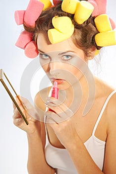 A woman in hair curlers