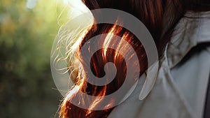 Woman hair flying in the wind in sunrise light