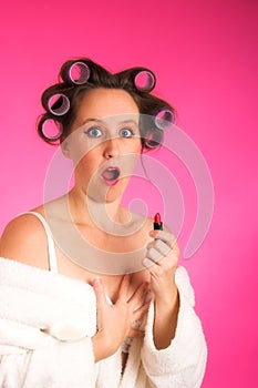 Woman in hair rollers and robe