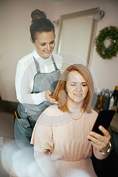 woman hair salon employee in modern beauty salon