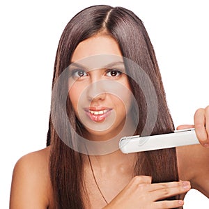 Woman with hair straightening irons