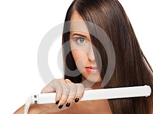 Woman with hair straightening irons