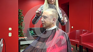 Woman hairdresser cut man client in own barbershop. 4K