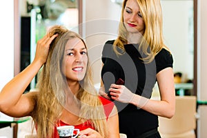 Woman at the hairdresser getting advise photo