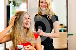 Woman at the hairdresser getting advise photo