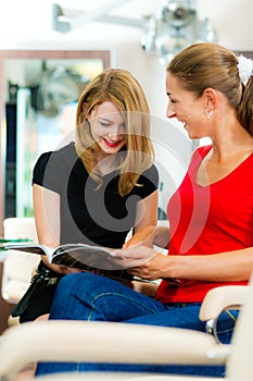 Woman at the hairdresser getting advise photo