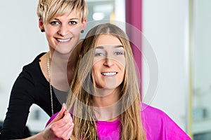 Woman at the hairdresser getting advise photo