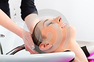 Woman at the hairdresser washing hair