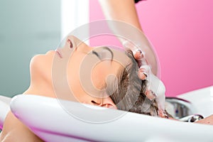 Woman at the hairdresser washing hair