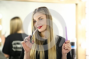 Woman Hairstylist with Comb and Scissors in Hands