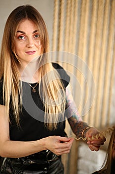 Woman Hairstylist Holding Curly Strand of Hair