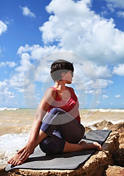 Woman in half spinal twist yoga pose