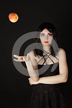 Woman with halloweeen make up sthrowing peach photo