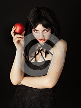 Woman with halloween make up holding red apple