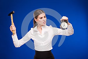 Woman with hammer and alarm clock