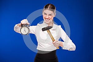 Woman with hammer and alarm clock