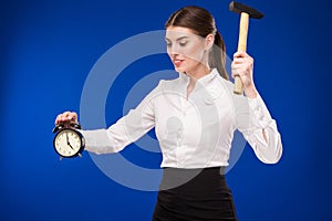 Woman with hammer and alarm clock