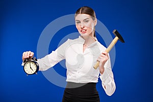 Woman with hammer and alarm clock