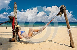 Woman in hammock on beach