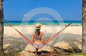 Woman in hammock on beach