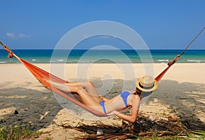 Woman in hammock on beach