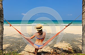 Woman in hammock on beach