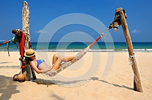 Woman in hammock on beach