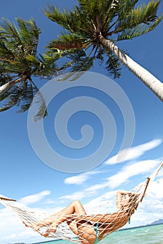 Woman in hammock on beach