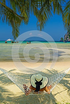 Woman on a hammock at the beach of Phi Phi Don island in Thailand photo