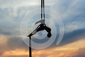 Woman in a hammock doing stunts.