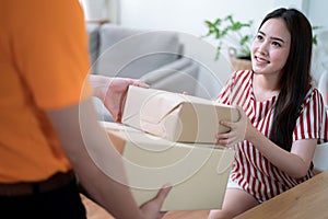 Woman hand accepting a delivery of boxes from deliveryman.