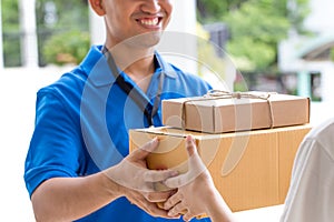 Woman hand accepting a delivery of boxes from deliveryman