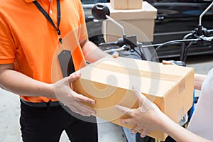 Woman hand accepting a delivery of boxes from deliveryman, Deliver goods by motorcycle service,