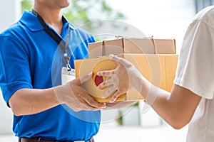 Woman hand accepting a delivery of boxes from deliveryman photo