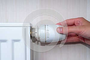 Woman Hand Adjusting Temperature By Thermostat