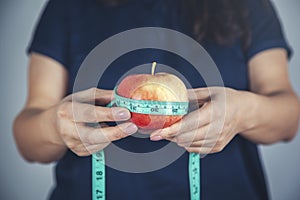 Woman hand apple with meters