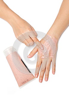 Woman hand applying spa scrub cream