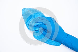 Woman hand in blue rubber gloves holds rag on white background. cleaning and regular clean up concept. Top view. flat lay.
